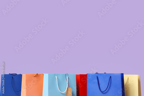 Many shopping bags on lilac...