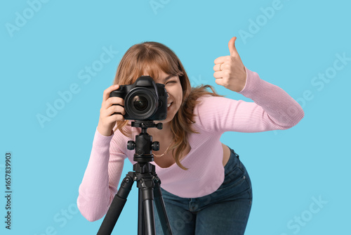 Young woman taking photo wi...