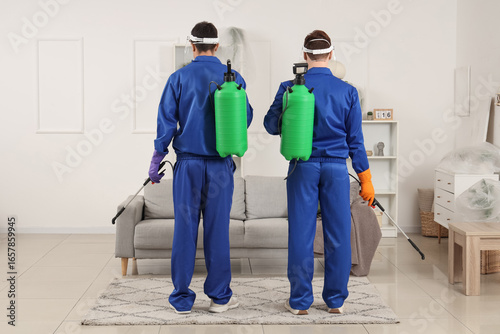Male workers with disinfect...