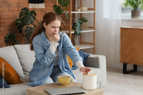 Sick young woman with tissu...