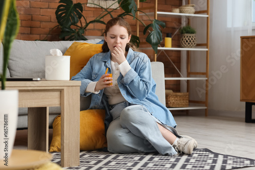 Sick young woman with pills...