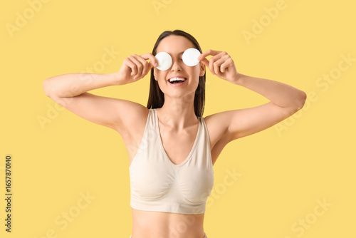 Young woman with cotton pad...