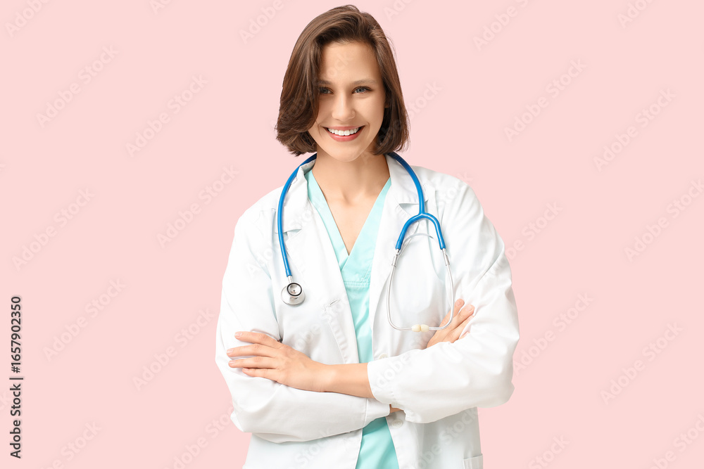 Happy female doctor with stethoscope on pink background Happy female doctor with stethoscope on pink background