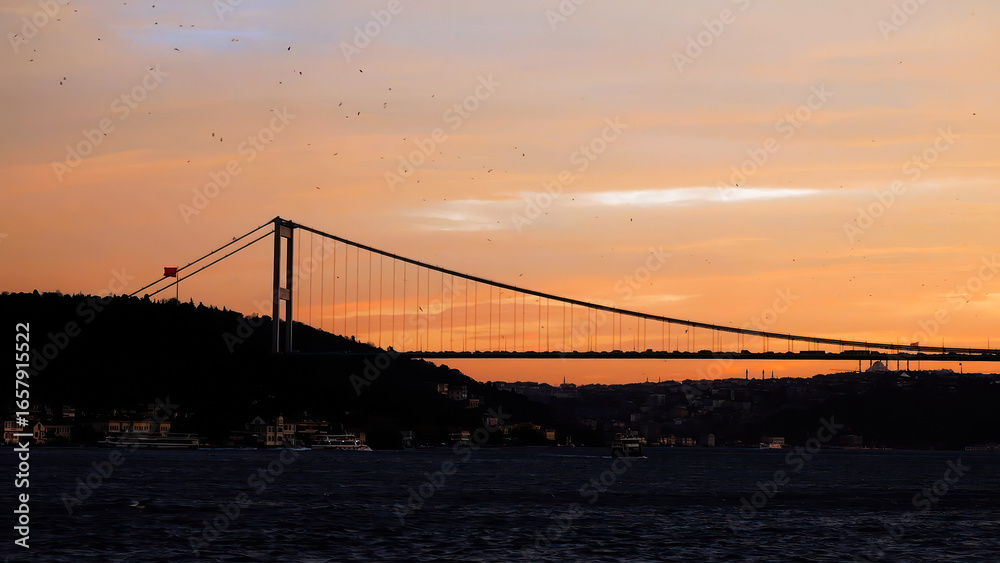 Obraz premium Panorama of cable-stayed bridge across Bosphorus. Istanbul, orange sunset sea