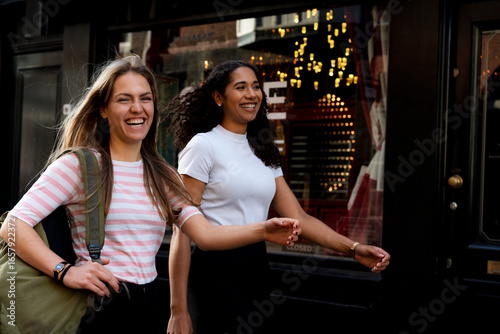 Two girlfriends on a city break, going on a shopping spree