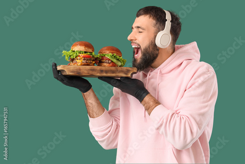 Young man with tasty burger...