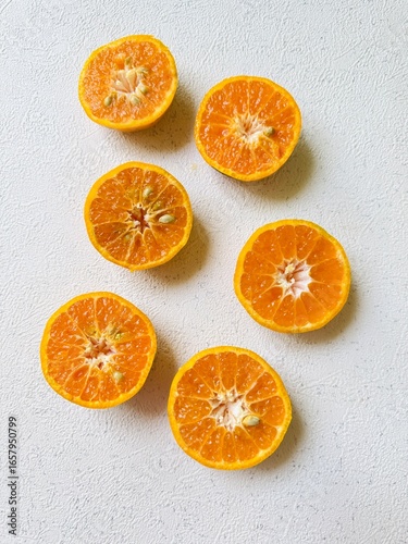 Halved Tangerines on a White Background 