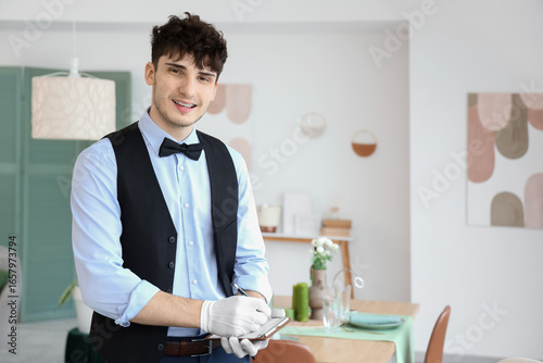 Male waiter writing on note...