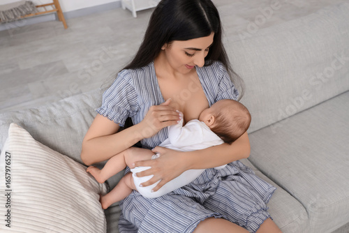Young mother breastfeeding ...
