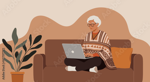 Elderly person comfortably using a laptop on a couch at home, highlighting modern senior living, digital literacy, and remote connectivity.
