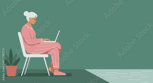 Smiling senior woman in pajamas comfortably works from home on her laptop. Perfect for themes of remote work, technology for seniors, and relaxed digital lifestyle.