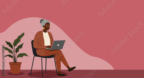 Mature Black woman using a laptop, representing digital literacy, remote work, or online learning for seniors. Modern lifestyle.