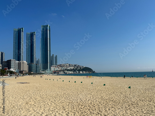 Busan South Korea skyline with illuminated skyscrapers overlooking Haeundae Beach at sunset