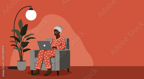 Elderly woman in pajamas using laptop at home, embodying remote work, digital literacy, and comfortable senior lifestyle.