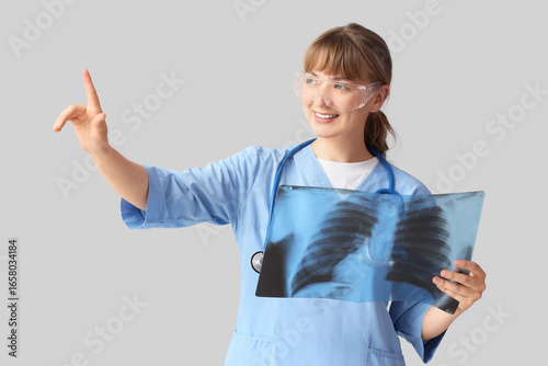 Medical diagnosis and healthcare technology, female doctor examining lung x-r...