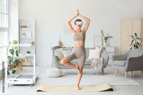 Sporty young woman in VR gl...