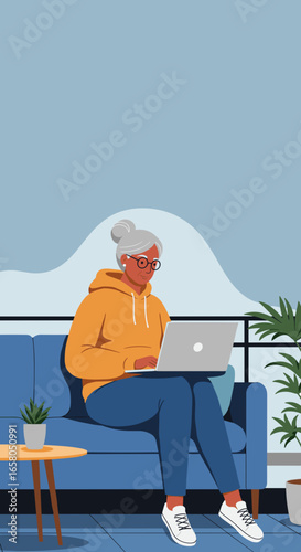 An elderly woman with grey hair uses a laptop on a sofa at home, representing remote work, digital connection, and modern senior lifestyle.