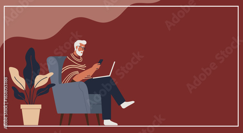 A modern senior man with beard and glasses relaxes in an armchair, simultaneously using a laptop and smartphone, illustrating digital engagement and connectivity.