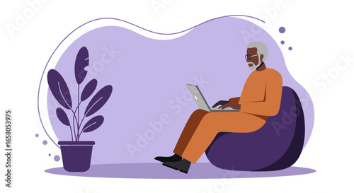 Senior man comfortably working on a laptop at home, representing remote work, modern lifestyle, and digital inclusion for older adults.
