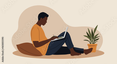 A young Black man comfortably works on his laptop at home, sitting on the floor with a pillow, ideal for remote work, online learning, or casual lifestyle.