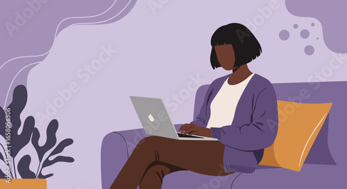 Woman focused on her laptop while relaxing on a comfortable couch at home. Ideal for remote work, online learning, or digital lifestyle concepts.