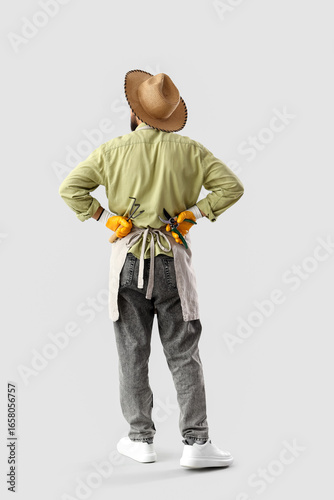 Male gardener on light back...