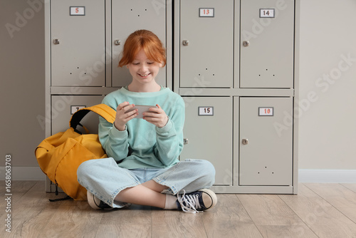 Teenage student using mobil...