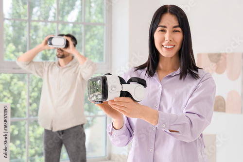 Young woman with VR glasses...
