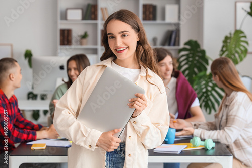 Female student with laptop ...