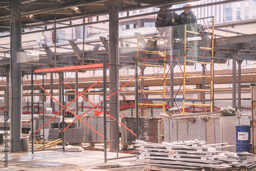 Εκτύπωση καμβά Two men working on construction site