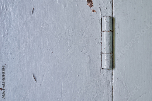 Close-up of a Weathered Door Hinge with Peeling Paint