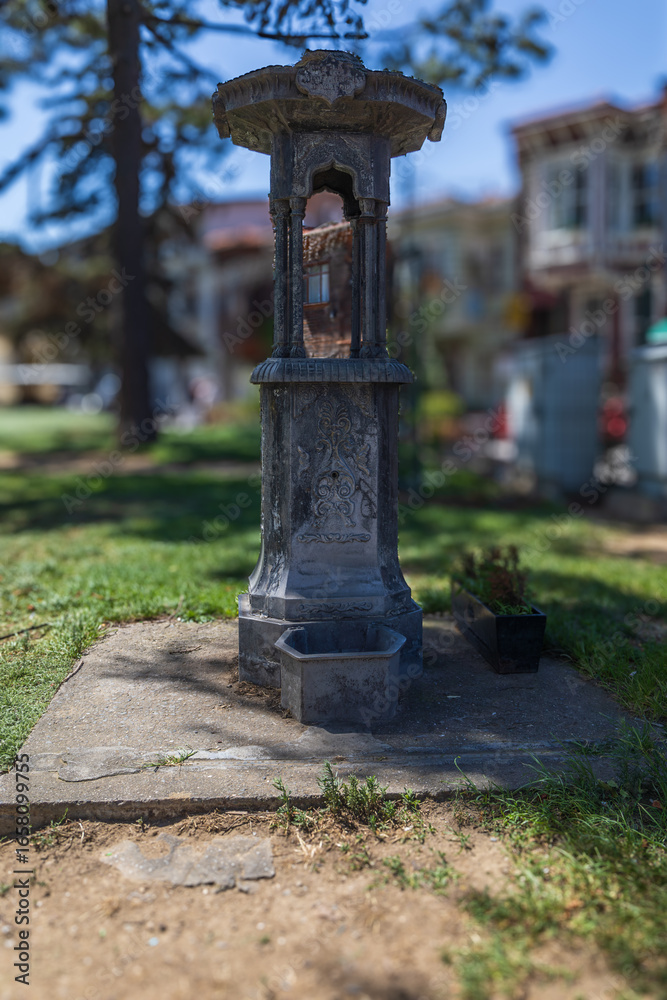 Obraz premium Old Ornamental Water Fountain in Park with Historic Design