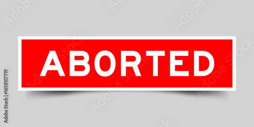 Red color square shape sticker label with word aborted on gray background
