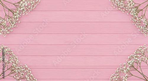 Pink wooden planks background with delicate white gypsophila flower arrangements in the corners.
