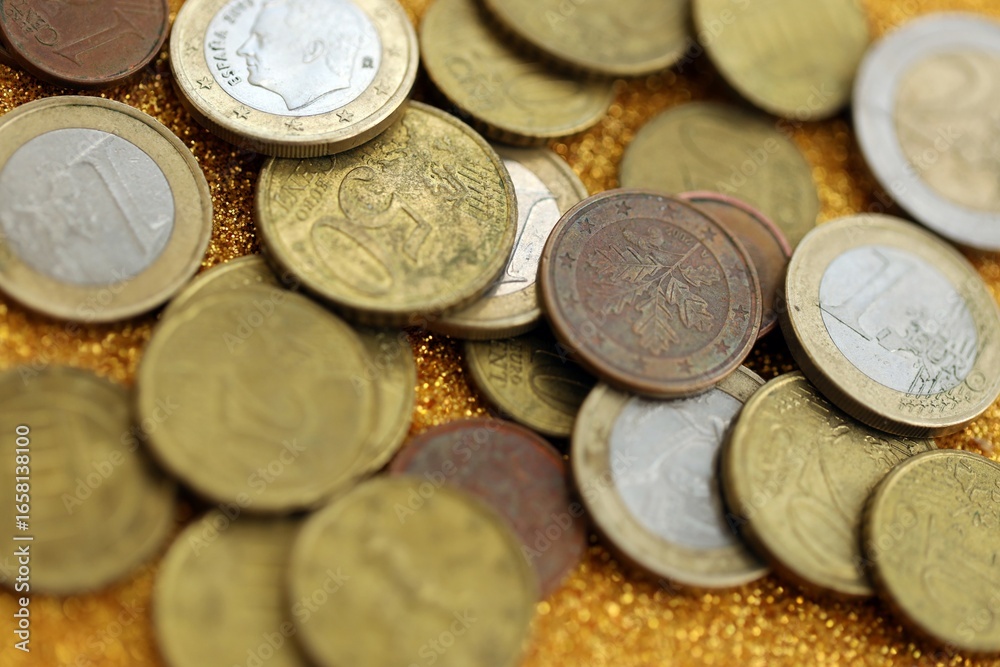 Big amount of euro coins on golden glitter background Big amount of euro coins on golden glitter background