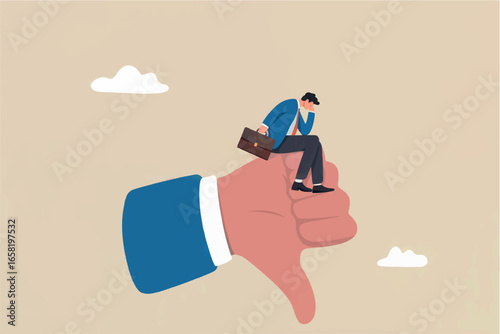 Disappointed businessman sitting on a giant thumbs down symbol reflecting failure and negative feedback concept
