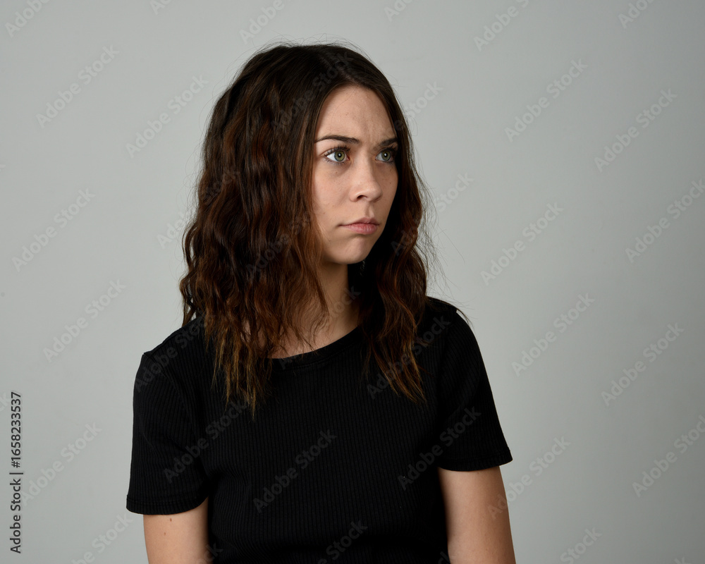 Fototapeta premium Brunette Girl Model Head and Shoulders Studio Portrait Fresh Faced and Pretty Showing expression emotional upset Expressions