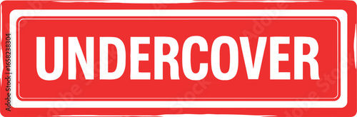 Bright red rectangular sign with white border and the word undercover in bold white lettering