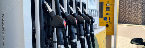Bild auf Leinwand Gasoline pumps at a fuel station with multiple nozzles and a digital display