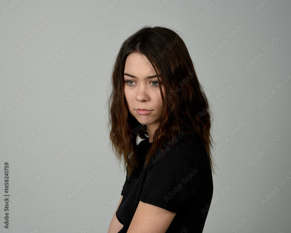 Obraz premium Brunette Girl Model Head and Shoulders Studio Portrait Fresh Faced and Pretty Showing expression emotional upset Expressions