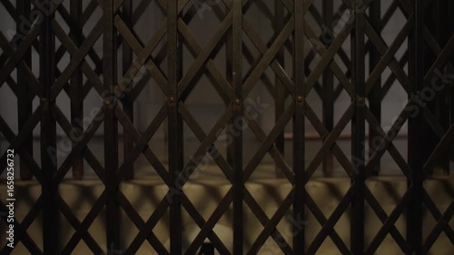 Old vintage elevator in a historic building with classic metal details and folding doors. Perfect for concepts of nostalgia, architecture and heritage.