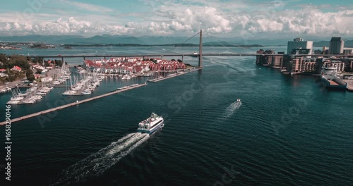 ferry in norway harbour with bridge in the background
