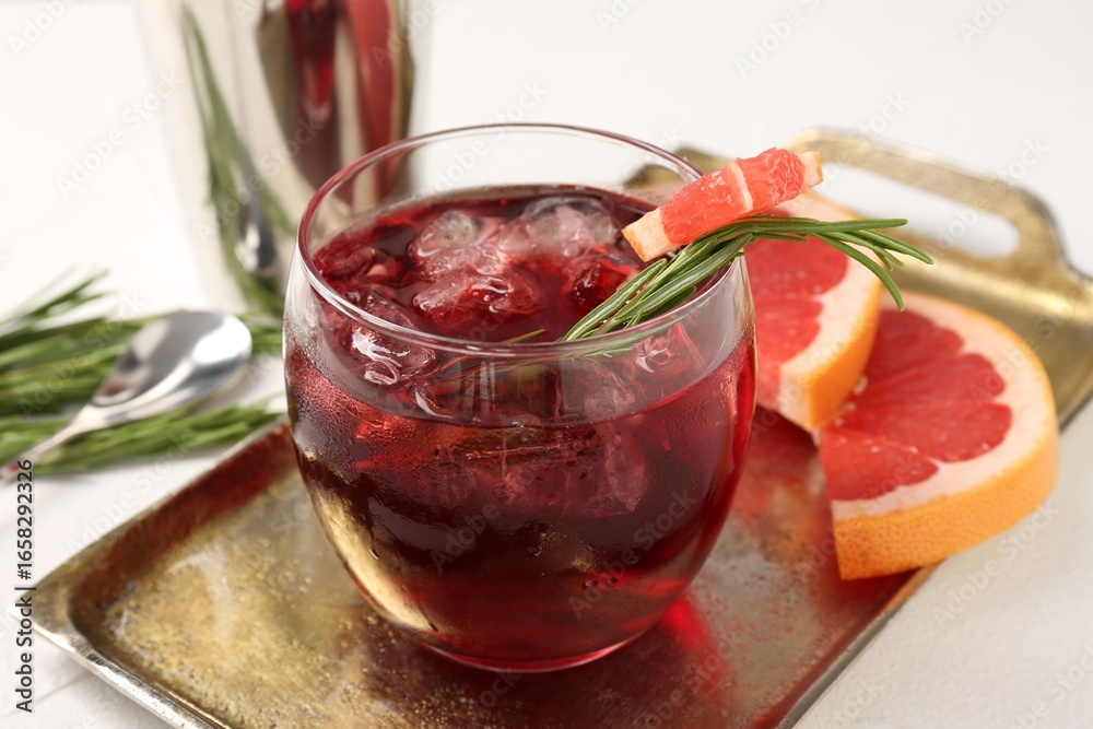 custom made wallpaper toronto digitalTasty cocktail with grapefruit, ice cubes and rosemary on white table, closeup