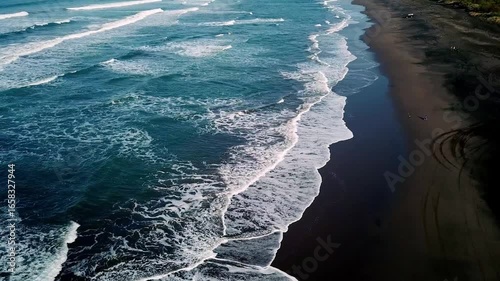 Aerial view of Parangtritis Beach in Bantul, Yogyakarta, Indonesia. Scenic coastline with rolling waves, golden sand, and tropical landscape, perfect for travel and tourism concepts.