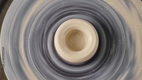 Pottery wheel spinning, shaping clay into a vase, close-up ceramic artistry in motion, focusing on