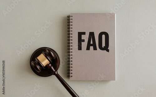 Legal FAQ and information concept, with a notebook for frequently asked questions about law and justice next to a judge's gavel.