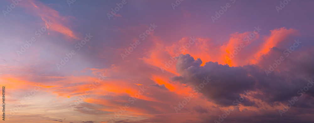 Fototapeta premium Aerial view amazing colorful pink sky in twilight above the ocean. romantic colorful sunrise scene with a bright colorful sky gradually turning into a dark night. Sky texture background.