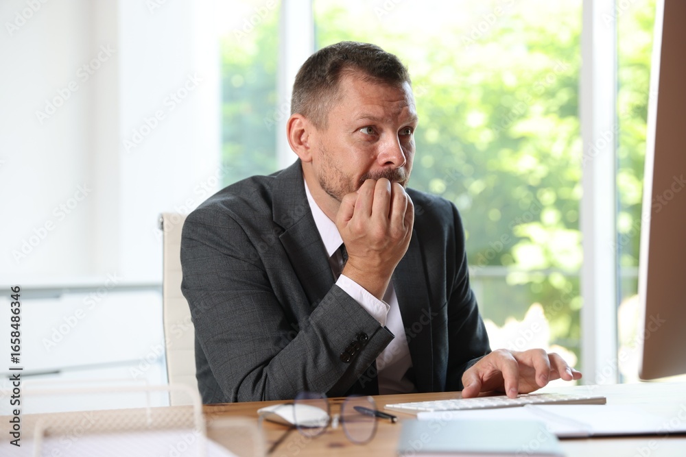 Naklejka premium Businessman suffering from panic attack at workplace in office