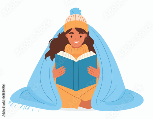 A young woman reading a book while wrapped in a blue blanket, wearing a winter hat and a turtleneck sweater.