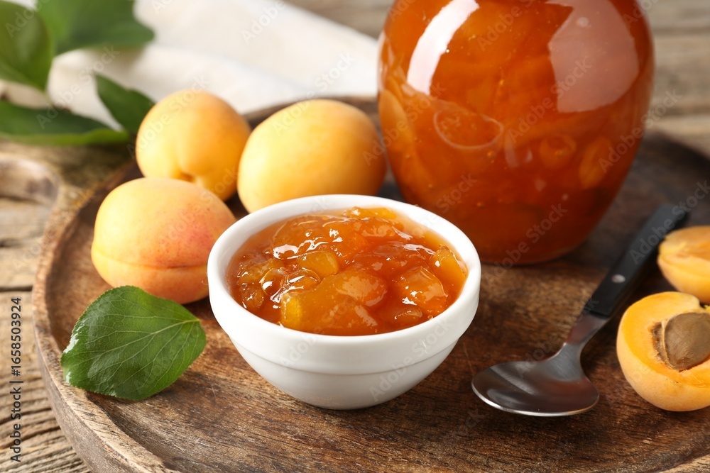 Tasty apricot jam and fresh fruits on wooden table, closeup Tasty apricot jam and fresh fruits on wooden table, closeup